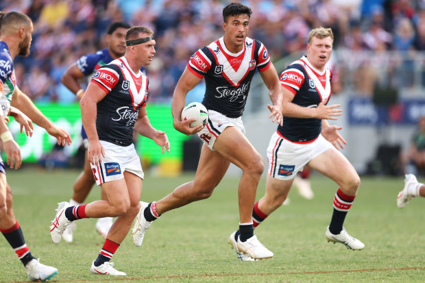 Joseph Suaalii of the Roosters makes a break.