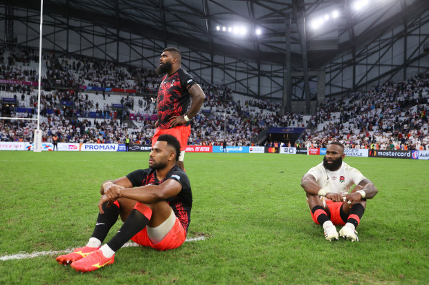 Vilimoni Botitu, Albert Tuisue and Semi Radradra of Fiji look dejected at full-time after their team's loss in the Rugby World Cup match against England. 