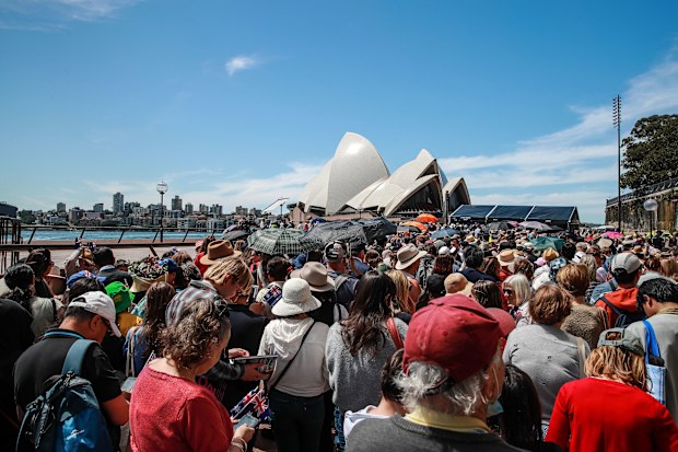 Members of the public gather outside Sydney Opera House prior to a visit from King Charles III and Queen Camilla at the Sydney Opera House on October 22, 2024 in Sydney, Australia. 