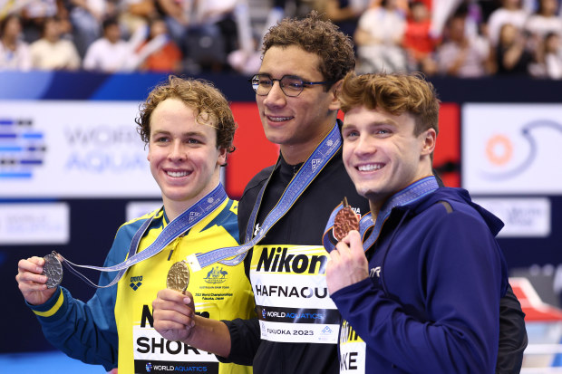 FUKUOKA, JAPAN - JULY 26:  Silver medallist Sam Short of Team Australia, gold medallist Ahmed Hafnaoui of Team Tunisia and  bronze medallist Bobby Finke of Team United States take a selfie during the medal ceremony for the Men's 800m Freestyle Final pose on day four of the Fukuoka 2023 World Aquatics Championships at Marine Messe Fukuoka Hall A on July 26, 2023 in Fukuoka, Japan. (Photo by Clive Rose/Getty Images)