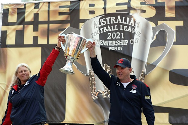 Demons Club President Kate Roffey and CEO Gary Pert hold the 2021 Premiership Cup on stage.
