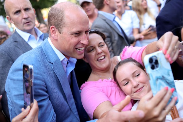 Prince William, Prince of Wales poses for selfies with members of the public as he visits Pret A Manger on September 07, 2023 in Bournemouth, England 