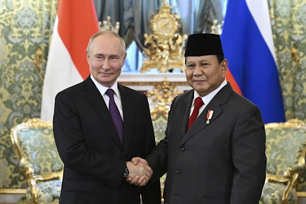 Russian President Vladimir Putin, left, and Indonesian Defense Minister and President-Elect Prabowo Subianto shake hands during their meeting at the Kremlin in Moscow, Russia, July 31, 2024. (Grigory Sysoyev, Sputnik, Kremlin Pool Photo via AP)