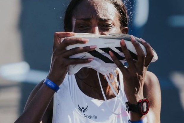 Tigst Assefa kisses her shoe after obliterating the women's marathon record.