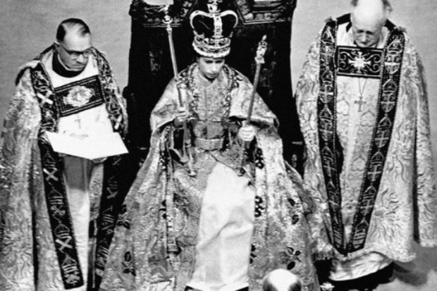 In 1953, the Coronation of Queen Elizabeth II took place at Westminster Abbey. Her Majesty is pictured during the Crowning Ceremony, seated on the Coronation Chair, wearing the St. Edward Crown and carrying the Sovereign's Sceptre and Rod.
