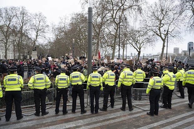 Police take measures as mourners for the life of murdered 33-year-old Sarah Everard, whose remains were found this week, take part in a demonstration outside New Scotland Yard in London