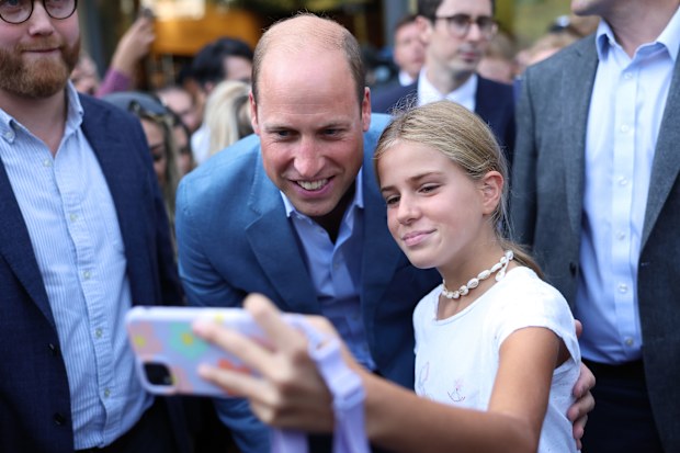 Prince William, Prince of Wales poses for selfies with members of the public as he visits Pret A Manger on September 07, 2023 in Bournemouth, England. 