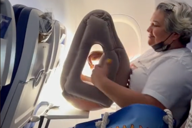 The passenger also used an oversized plane pillow on the flight.