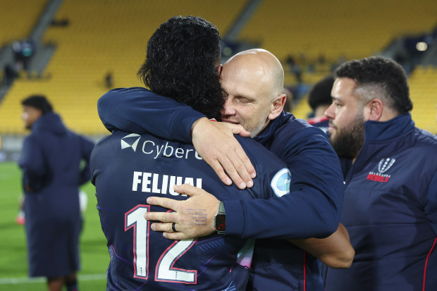 Rebels coach Kevin Foote hugs David Feliuai after the Super Rugby Pacific quarter-final against the Hurricanes.