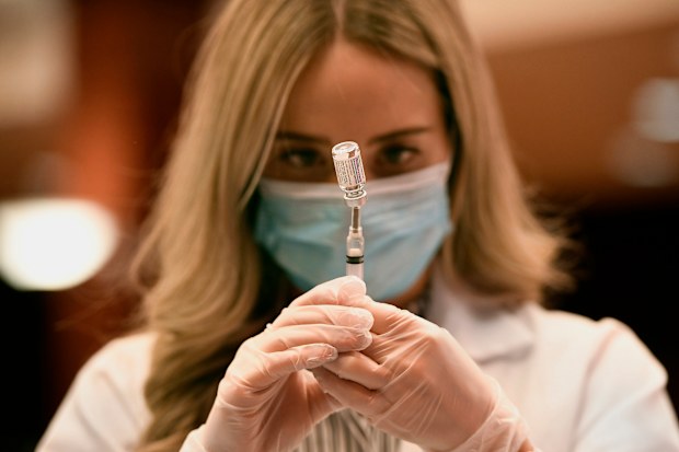 Pharmacist Madeline Acquilano draws a syringe of Johnson & Johnson COVID-19 at Hartford Hospital in Hartford, Connecticut.