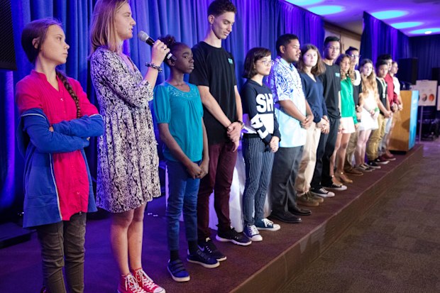 Iris Duquesne of France, second from left, is joined by other child petitioners to announce a complaint they will file before the United Nations Committee.