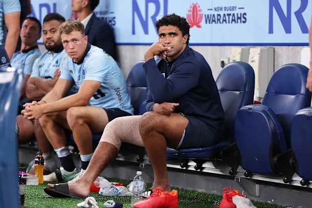 Langi Gleeson of the Waratahs sits on the bench.
