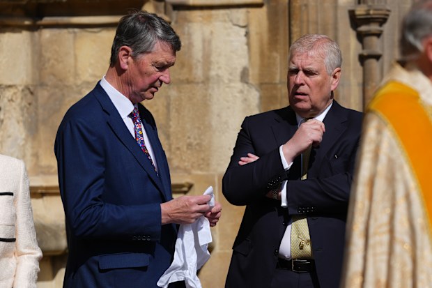 Timothy Lawrence, left, husband of Princess Anne, left speaks to Prince Andrew 