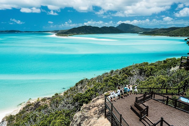 Aerial view of people looking out over the blue waters, from Hill Inlet Lookout