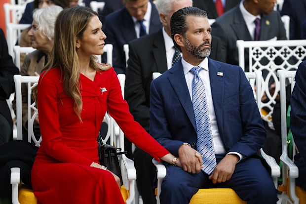 Donald Trump Jr. sits with his girlfriend Bettina Anderson prior to a Presidential Medal of Freedom ceremony in the Rose Garden of the White House on October 14, 2025