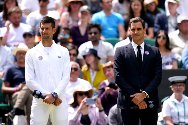 Former Wimbledon champions Novak Djokovic (left) and Roger Federer on centre court during day seven of the 2022 Wimbledon Championships at the All England Lawn Tennis and Croquet Club, Wimbledon. Picture date: Sunday July 3, 2022. (Photo by John Walton/PA Images via Getty Images)