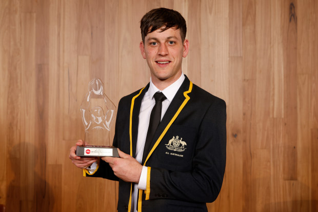 Zak Butters poses with his AFLCA Most Courageous Player Award.
