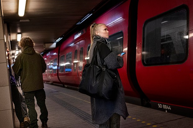 Passengers at Noerreport train station in Copenhagen Denmark on February 1, 2022. Restrictions have been lifted in Denmark. 