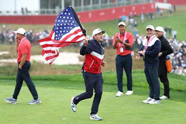 USA captain Keegan Bradley runs the 18th hole with an American flag during a practice round prior to the Ryder Cup.