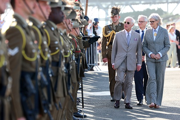 King Charles III and Governor-General of the Commonwealth of Australia, Her Excellency The Honourable Sam Mostyn walk a Guard comprising selected members of Their Majesties' affiliated units, the 1st Armoured Regiment and the Royal Australian Corps of Military Police at the Sydney Opera House with the Sydney Harbour Bridge in the background on October 22, 2024 in Sydney, Australia. 