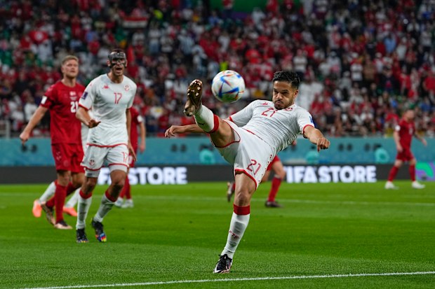 Tunisia's Wajdi Kechrida clears the ball during the World Cup group D soccer match between Denmark and Tunisia, at the Education City Stadium in Al Rayyan, Qatar, Tuesday, Nov. 22, 2022. The match ended in a 0-0 draw.