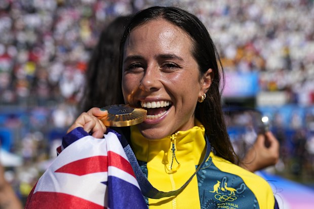 Noemie Fox of Australia celebrates with the gold medal in the women's kayak cross finals during the canoe slalom at the 2024 Summer Olympics, Monday, Aug. 5, 2024, in Vaires-sur-Marne, France.