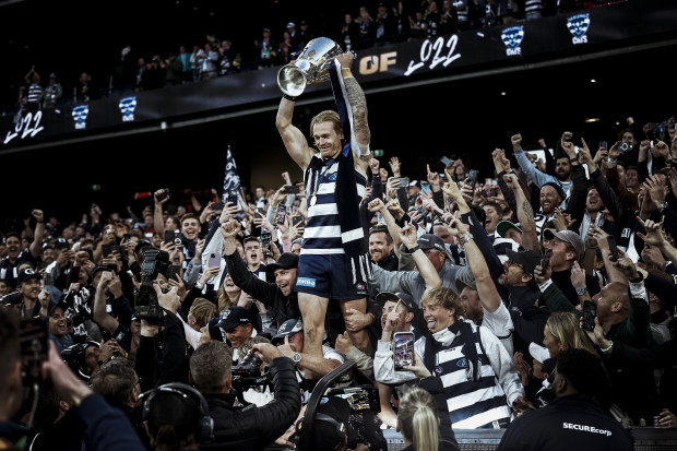 MELBOURNE, AUSTRALIA - SEPTEMBER 24: Tom Stewart of the Cats celebrates with the Premiership Cup after the 2022 AFL Grand Final match between the Geelong Cats and the Sydney Swans at the Melbourne Cricket Ground on September 24, 2022 in Melbourne, Australia. (Photo by Darrian Traynor/AFL Photos/via Getty Images)