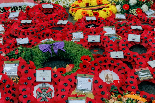 Poppies and other floral wreaths lie, during an Armistice Day ceremony at the Menin Gate Memorial to the Missing in Ypres, Belgium, Friday, November 11, 2022
