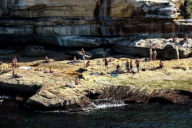 People are seen on rocks at the south end of Bondi Beach in Sydney, Australia.