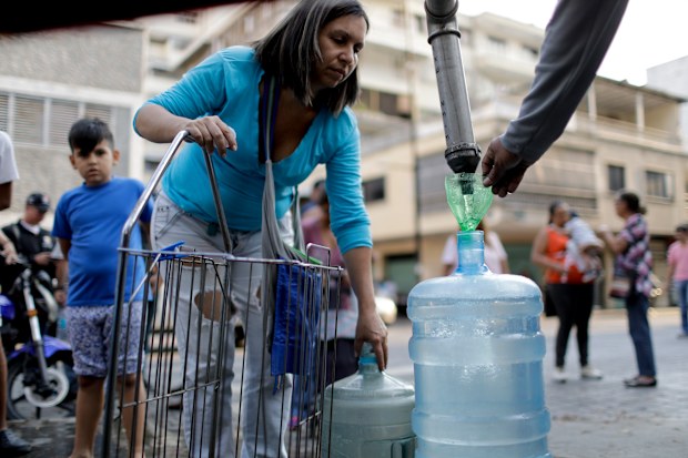Locals in Venezuela venture the streets far and wide for rare sources of fresh water as mass blackouts continue throughout the country.
