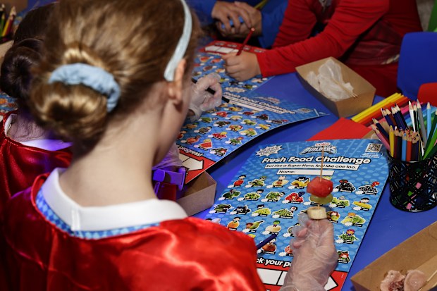 Primary school students attend the Coles Super Hero Builders collectables campaign launch