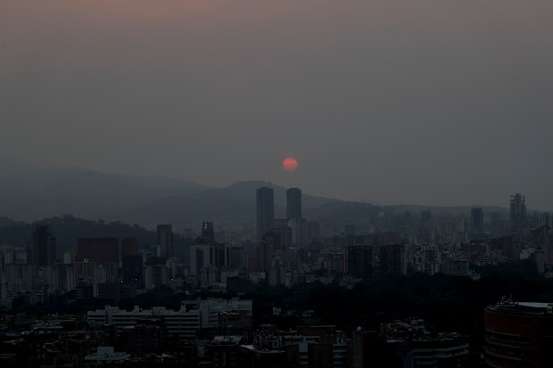 As the sun sets each night, vast stretches of the country are covered in pitch darkness as rolling blackouts continue to wreak havoc on Venezuela. (AP Photo/Natacha Pisarenko)