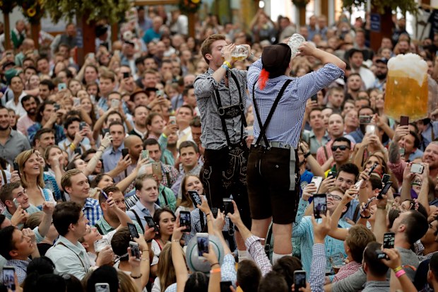 Two men drink beer during the opening of the 185th 'Oktoberfest' beer festival in Munich, Germany.