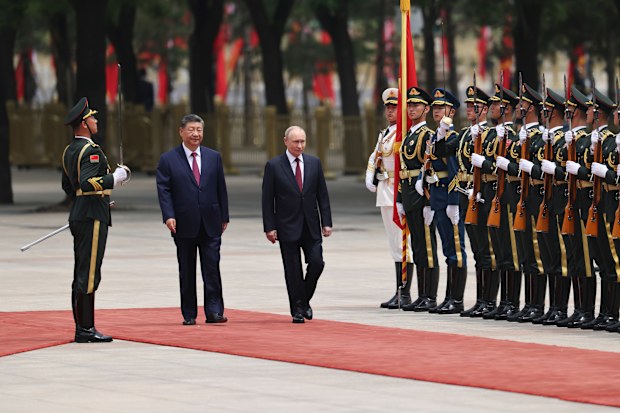 Russian President Vladimir Putin, center right, and Chinese President Xi Jinping, center left, inspect an honor guard during a welcoming ceremony at the Great Hall of the People in Beijing Wednesday, May 20, 2026. (Maxim Shemetov/Pool Photo via AP)