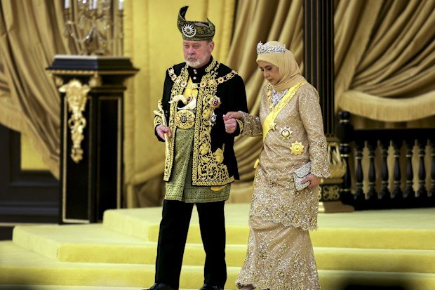 The 17th King of Malaysia, Sultan Ibrahim Iskandar, left, and Queen Raja Zarith Sofiah walk near the throne during his coronation at the National Palace in Kuala Lumpur, Malaysia, Saturday, July 20, 2024. (Hasnoor Hussain/Pool Photo via AP)