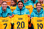 Steph Catley, Sam Kerr and Katrina Gorry of the Matildas pose with their jerseys during Australia's World Cup squad presentation at Federation Square on July 11, 2023. 