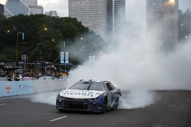 Shane Van Gisbergen, driver of the No.91 Chevrolet Camaro, celebrates with a burnout after winning the NASCAR Cup Series race at the Chicago Street Course.