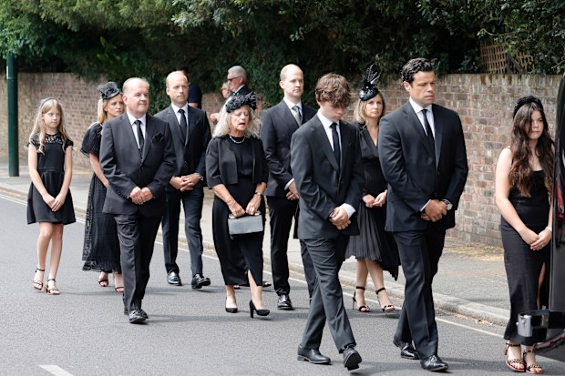 Hugo Bowen, Sebastien Bowen and Eloise Bowen lead the procession with (L-R second row) parents Alistair James, Heather James and brother Ben James during the funeral of Dame Deborah James at St Mary's Church on July 20, 2022 in Barnes, England.  