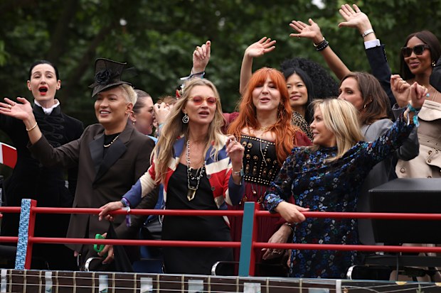 Erin O'Connor, Kate Moss, Charlotte Tilbury and Naomi Campbell ride a bus along the mall during the Platinum Pageant on June 05, 2022 in London, England.  