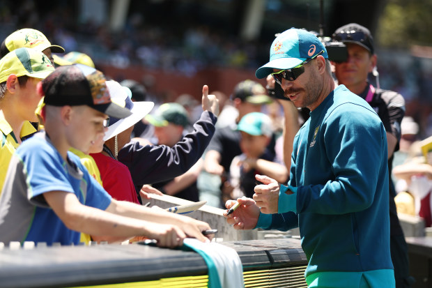 David Warner signs autographs for fans at the Adelaide Oval in the second Test match against the West Indies.