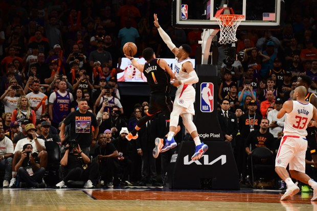 PHOENIX, AZ - APRIL  16: Russell Westbrook #0 of the LA Clippers blocks the shot by Devin Booker #1 of the Phoenix Suns, winning Round One Game One of the 2023 NBA Playoffs on April 16, 2023 at Footprint Center in Phoenix, Arizona. NOTE TO USER: User expressly acknowledges and agrees that, by downloading and or using this photograph, user is consenting to the terms and conditions of the Getty Images License Agreement. Mandatory Copyright Notice: Copyright 2023 NBAE (Photo by Kate Frese/NBAE via 