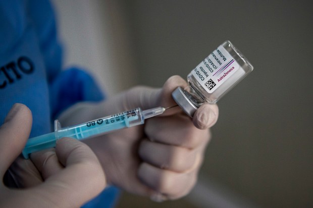 A healthcare worker of the Italian Army prepares doses of the AstraZeneca COVID-19 vaccine.