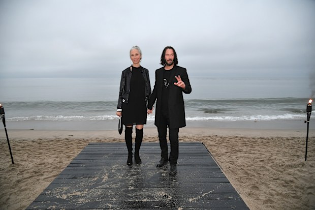 Alexandra Grant and Keanu Reeves attend the Saint Laurent Men's Spring Summer '20 Show on June 6, 2019 in Malibu, California