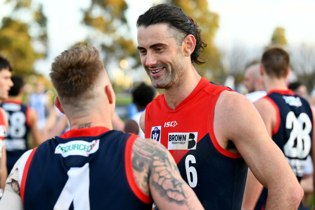 MELBOURNE, AUSTRALIA - AUGUST 27: Brodie Grundy of the Demons speaks with James Harmes after winning the 2023 VFL Wildcard Round match between the Casey Demons and the North Melbourne Kangaroos at Casey Fields on August 27, 2023 in Melbourne, Australia. (Photo by Josh Chadwick/AFL Photos via Getty Images)