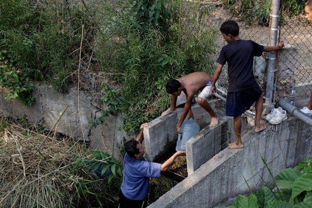 Out of desperation, people in Venezuela are even crawling into dirty canals to try and source water supplies to carry back to their homes.