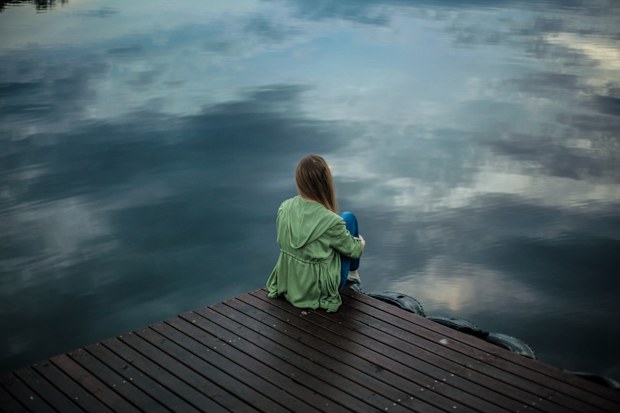 Gaslighting, woman sitting alone