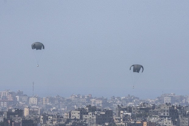 Parachutes drop supplies into the northern Gaza Strip, as seen from southern Israel, Thursday, March 21, 2024 