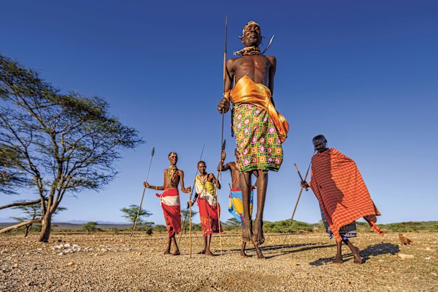 African warrior from Samburu tribe performing a traditional jumping dance, central Kenya. Samburu tribe is one of the biggest tribes of north-central Kenya, and they are related to the Maasai.
