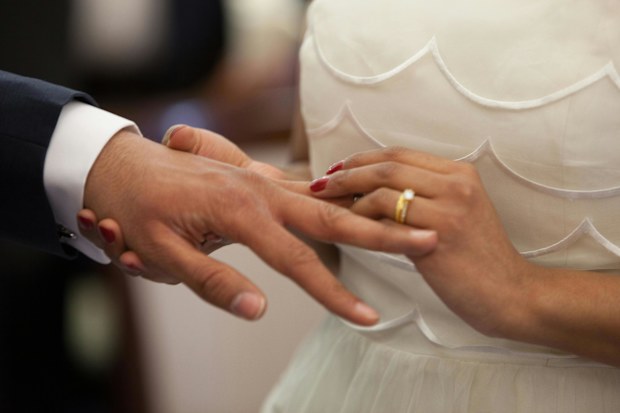 Couple exchange rings on their wedding day stock image