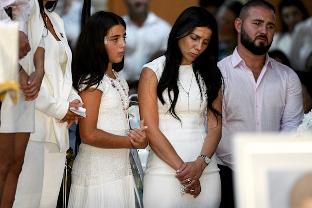 Leila Geagea (middle) and daughter (left) are seen during the funeral for her children Antony Abdallah, 13, Angelina Abdallah, 12, and Sienna Abdallah, 8, at Our Lady of Lebanon Co-Cathedral in Sydney, Monday, February 10, 2020.